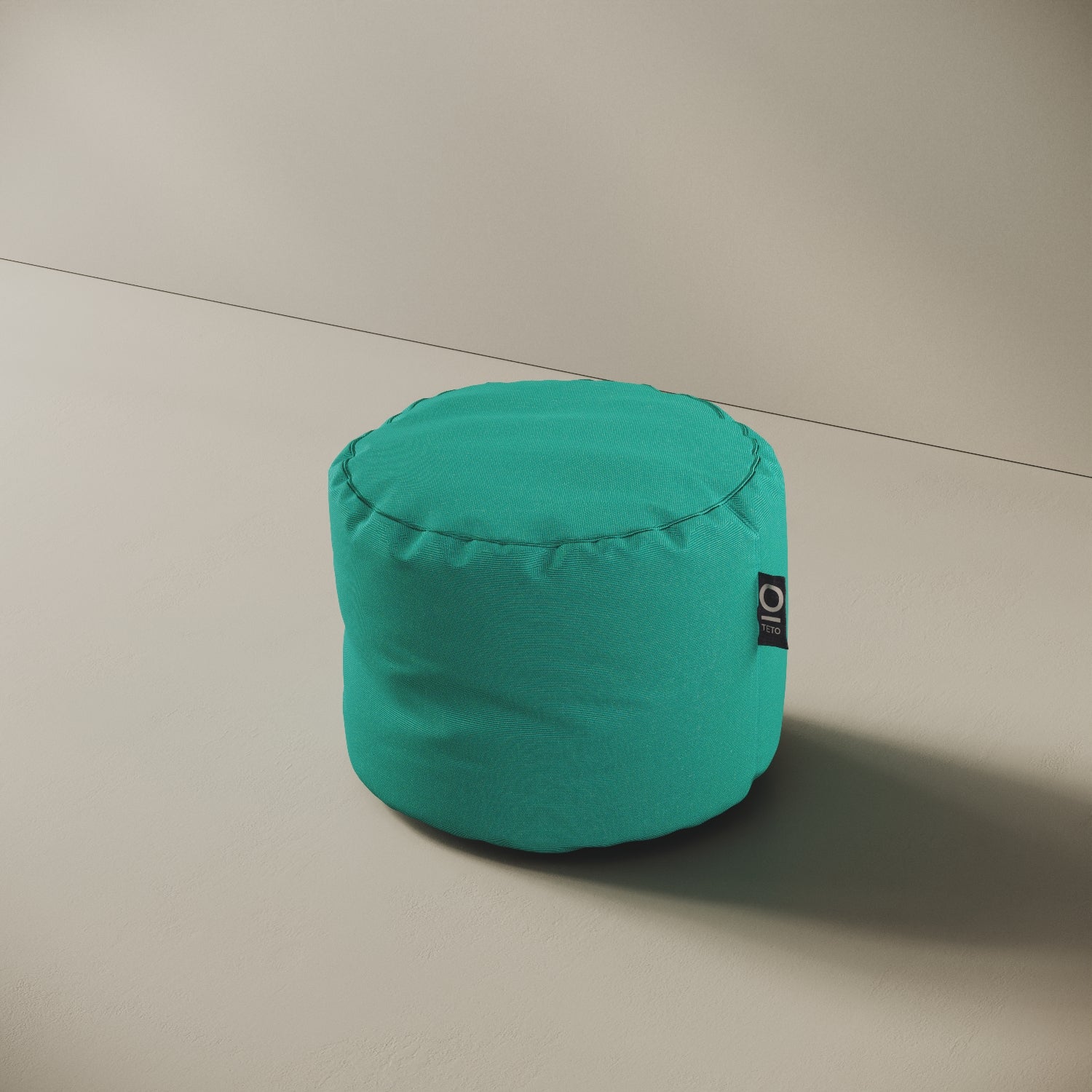 Pouf Adapto turchese, vista laterale — forma cilindrica stabile, ideale come seduta o poggiapiedi